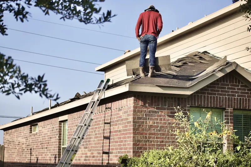 Professional roofer working on a residential roof in Sagaponack